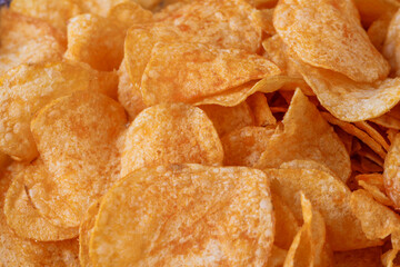 Potato chips or crisps . Close-up of potato chips or crisps. Food background.