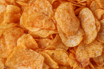 Potato chips or crisps . Close-up of potato chips or crisps. Food background.