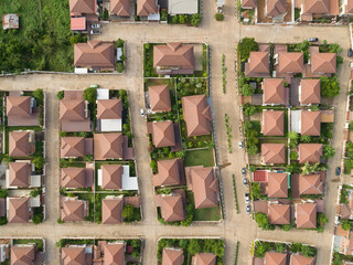 Aerial drone view of small winding sreets and roads in a residential area of a small town. - An aerial top down view of houses patterns on road.