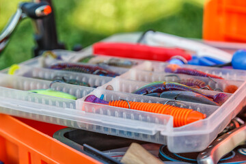 A large fisherman's tackle box fully stocked with lures and gear for fishing.fishing lures and accessories.Fishing tackle - fishing spinning. Kit of fishing lures.