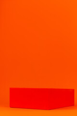 Minimal modern product display geometrical podium demonstrating on orange background monochrome. Empty pedestal shelf display tangerine color minimal style. Blank stand showing cosmetic beauty product