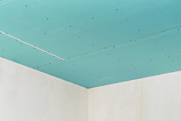 Plasterboard ceiling on an installed profile frame. Apartment or office renovation. A cheap and quick way to make a partition or ceiling in a room or warehouse.