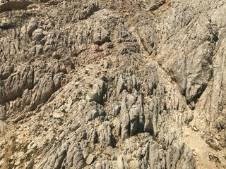 Rocky texture. Sandstone wall in medieval cathedral style. Chaotic masonry structure