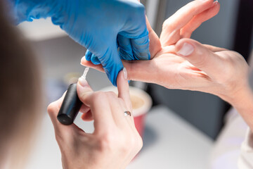 Performing manicure work in a beauty salon.