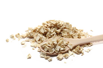 Pile dry chopped parsnip root in wooden spoon isolated on white  - obrazy, fototapety, plakaty
