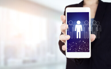 HR Human Resources Recruitment Employment. Hand hold white smartphone with digital hologram Human, Leader sign on light blurred background. Human resources and team management concept.