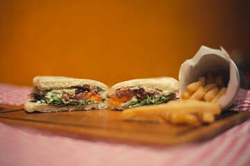 Tasty sandwich on arabe bread with tomato, beef blend on a rustic background.