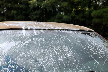 Naklejka na ściany i meble Car maintenance with the washing in the car foam under pressure