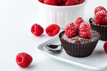 Chocolate raspberry mousse filled cups topped with raspberries.