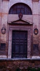Old vintage wooden front door in an italian city. 