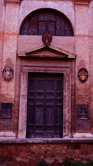 Fototapeta na wymiar Medieval church arch portal on stone blocks facade