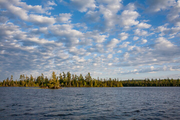 Lake in northern Minnesota with altocumulus clouds on a sunny afternoon - obrazy, fototapety, plakaty