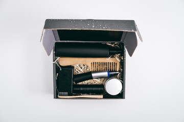 Men self care kit, black gift box with male beauty care products and devices. Man self care package or gift box for boyfriend, husband, father or brother.