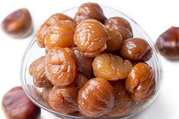 Chestnut dessert and chestnuts on a plate. Traditional delicious Turkish dessert; chestnut candies (Kestane Sekeri)