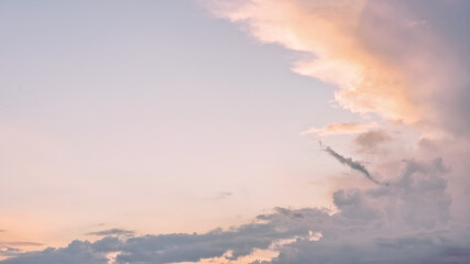 Fototapeta na wymiar Dramatic cloudy pastel colored sunset sky