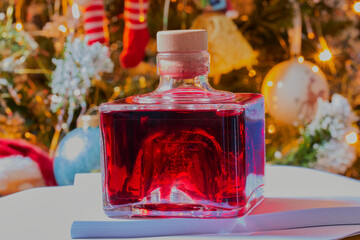 Bottle of Christmas gin,with festive decorations in the background.