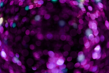 Bokeh purple on a black background. Blur and bokeh abstract , vibrant colors and textured. Good wallpapers .Copy space.
