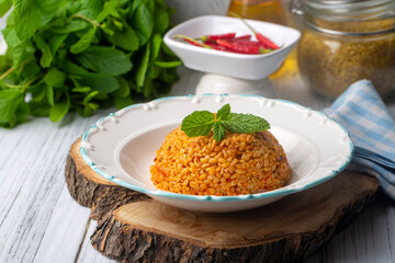 Traditional turkish bulgur pilaf with tomato sause in plate (Turkish name; meyhane pilavi)