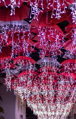 Street decoration, Christmas lights, red and white, falling from umbrellas.