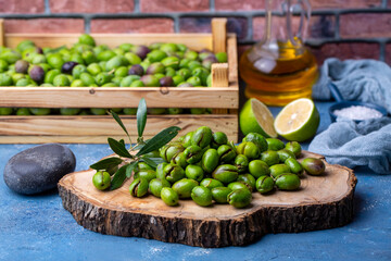 Homemade crushing olive making. Fresh green olives are breaking one by one. Crushing olives with stone. Preparing pickled olives in Turkish style. (Turkish name; kirma zeytin)