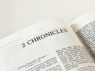 Obraz premium 2 Chronicles open Holy Bible Book on white background. A close-up. Studying Old Testament Scripture inspired by God Jesus Christ. Biblical concept.