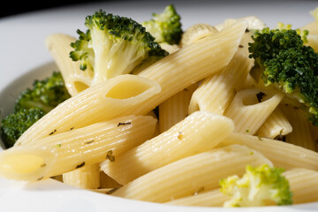 pasta with broccoli on a black background