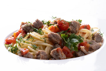 Pasta in tomato sauce and meat on white plate and white background.