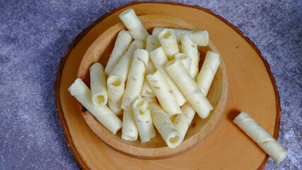 Christmas cake, vanilla wafer roll stick on a wooden bowl. Food Photography, Food and beverages concept.