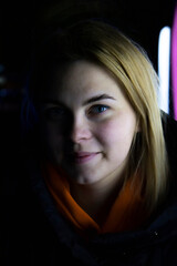 Girl's face with blue eyes on a black background.