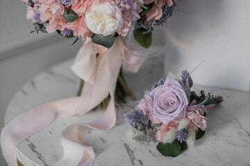 Stylish bridal bouquet and a boutonniere for the groom of preserved flowers. Wedding bouquet of white and pink roses. Close up of wedding bouquet.