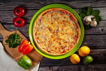 Obraz na płótnie Canvas pizza with cheese on a dark background