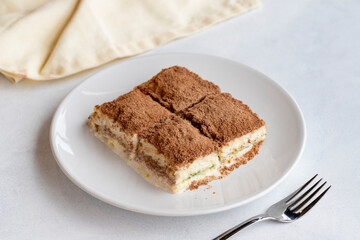 Cold baklava on a dark background. Turkish sweet dessert concept. plate of sliced forest fruit cake. Plate of cold milk baklava. Mediterranean bakery. close up. selective focus. soguk baklava