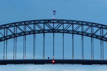 Close-up view of Sydney Harbour Bridge with blue sky.