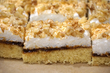 Layered biscuit cake with egg white snow and chopped nuts