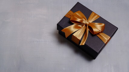 Cute gift box with satin ribbon on the table. Christmas and new year concept, Valentine Concept....