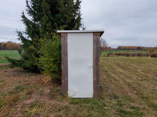 A single toilet building in a country garden