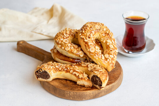 Turkish Ay coregi and tea. moon cookie on white background. Croissant with chocolate cocoa and raisin. Close up. Selective focus. Horizontal view