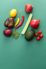 various fruits and vegetables on green background