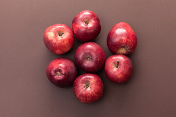 many red apples isolated on brown background