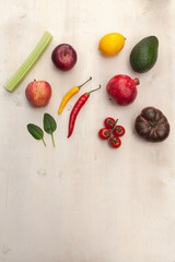 various fruits and vegetables on white wooden background