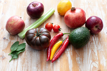 various fruits and vegetables on light wooden background