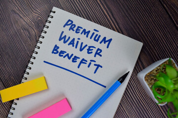 Premium Waiver Benefit write on a book isolated on Wooden Table.