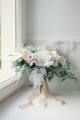 Delicate winter wedding bouquet of flowers by the window, winter style