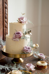 White wedding cake on the golden stand, wedding reception