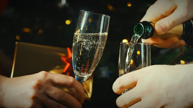 Pouring champagne into a glass. Celebrating new year or christmas.