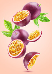 Ripe bright passionfruit and cut pieces levitate with leaves isolated on a beige background.