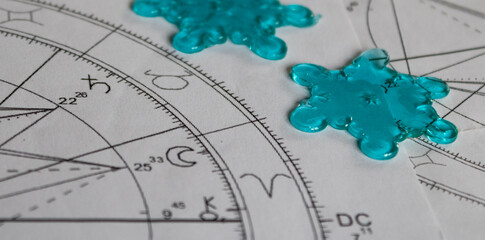 Detail of printed astrology chart with Saturn planet and two snowflake stickers