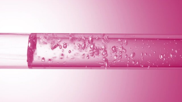 Transparent liquid flows in glass tube creating transparent different sized bubbles with on pale pink background | Abstract face care cosmetics formulating concept