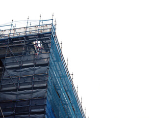 Scaffolding metal frame with blue safety net on white background. Building construction and repair.