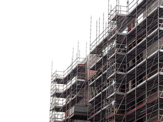 Modern home of office building construction with scaffolding. White background. New house development. Construction industry.